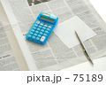 電卓と英字新聞とペンとメモ