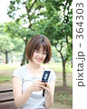 携帯電話でメールをする女性