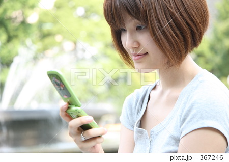 携帯電話でメールをする女性
