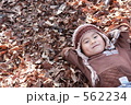落ち葉の上で寝る子供