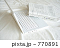 ノートパソコンと経済新聞