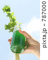 ドリンク（野菜ジュース）を持つ女性の手と空
