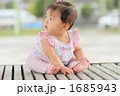 東屋のベンチに座って後を振り向く赤ちゃん