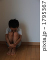 膝を抱えて座る男児　３