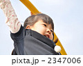 公園の遊具で元気に遊ぶ女の子