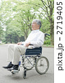 車イスで公園を散歩するシニア
