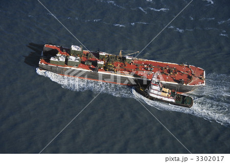 Tugboat pushing ship.