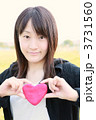 ハートを持った20代女性（笑顔）