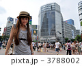 渋谷のスクランブル交差点に立つ若い女性