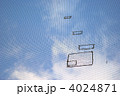 防球ネットのツギハギと青空
