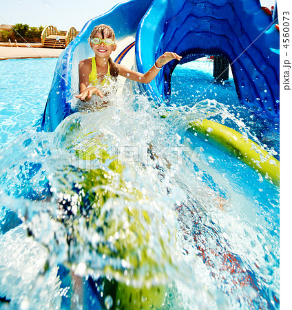 Child on water slide at aquapark. Child on water slide at aquapark.