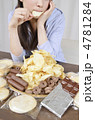 おやつの山と食べる女性