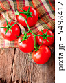 Fresh tomatoes on vintage wooden cutting board and linen towel