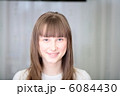 A Relaxed Young Woman Smiling With Hand On Chin