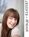 A Relaxed Young Woman Smiling With Hand On Chin