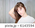 A Relaxed Young Woman Smiling With Hand On Chin