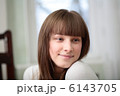 A Relaxed Young Woman Smiling With Hand On Chin
