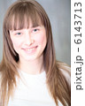 A Relaxed Young Woman Smiling With Hand On Chin