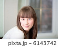 A Relaxed Young Woman Smiling With Hand On Chin