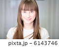 A Relaxed Young Woman Smiling With Hand On Chin