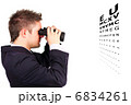 Man doing an eye test with binoculars
