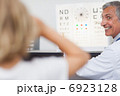 Joyful doctor doing an eye test on a patient in a hospital