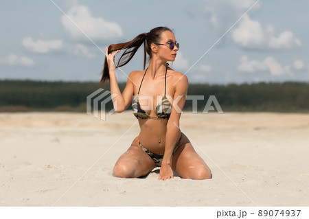 Sensual Woman Kneeling On Beach Pixta