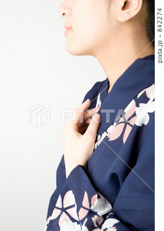 胸に手を当てる和服の女性の写真素材