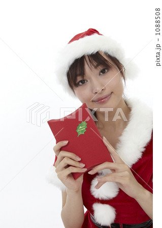プレゼントを持つ、サンタ衣装を着た女性 1088508