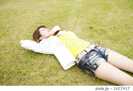仰向け 寝転ぶ 女性の写真素材
