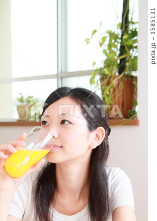 オレンジジュースを飲む女性 1585131