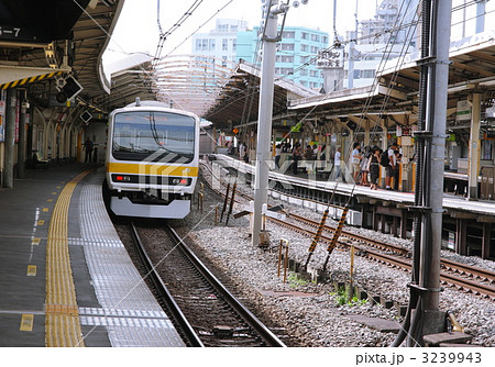 代々木駅ホームの総武線電車の写真素材