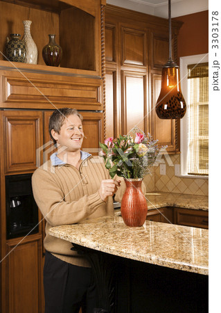 Man arranging flowers. 3303178