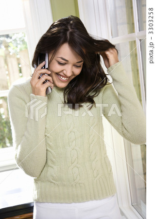 Woman on cellphone smiling. Woman on cellphone smiling. 3303258
