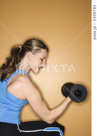 Woman lifting weights. 3309785
