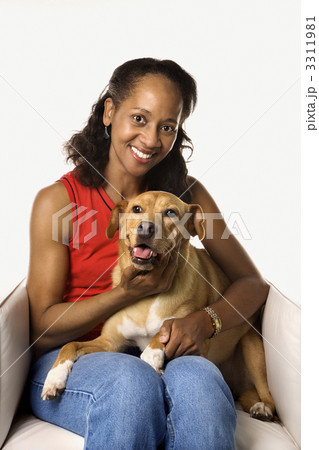 Woman holding and petting dog. 3311981