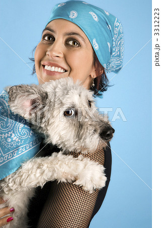 Smiling young woman holding dog. Smiling young woman holding dog. 3312223