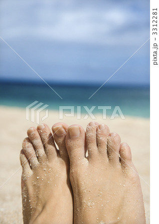 Woman's sandy feet on beach. 3312281