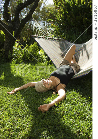 Woman lounging on hammock. Woman lounging on hammock. 3316967