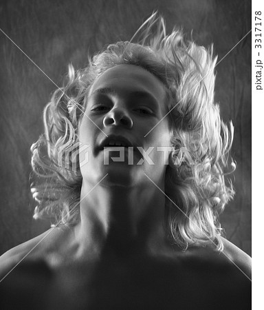 Teen boy flipping hair back. 3317178