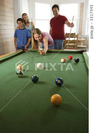 Family Playing Pool in Rec Room 3317345