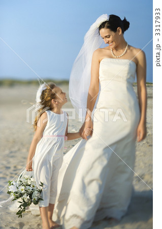 Bride and Flower Girl on Beach 3317933