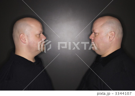 Twin men staring. 3344107