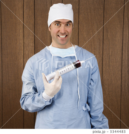 Surgeon holding syringe. Surgeon holding syringe. 3344483