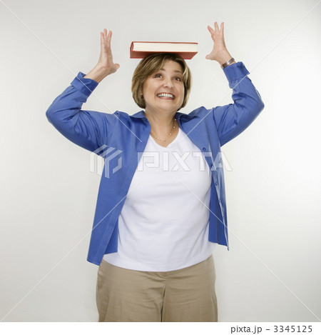 Woman balancing book. 3345125