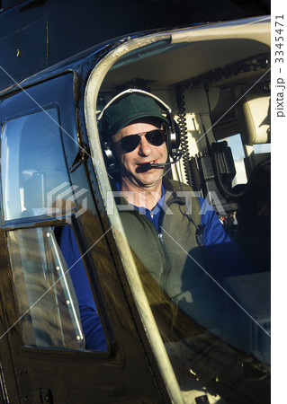 Male pilot in helicopter. 3345471