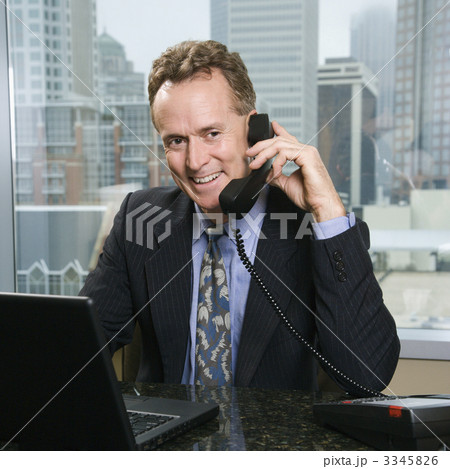 Businessman on phone in office. 3345826
