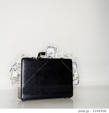 Briefcase overflowing with money Briefcase overflowing with money 3346406