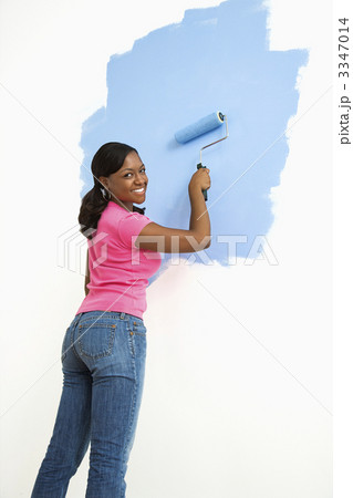 Pretty woman painting wall. 3347014