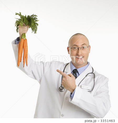 Doctor holding carrots. Doctor holding carrots. 3351463